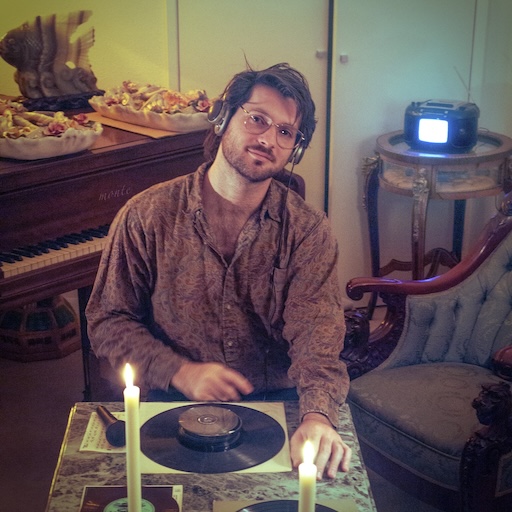 Cover art for Taste Like Silence by Monte Lately. Monte Lately sitting at a table next to a piano in candlelight.